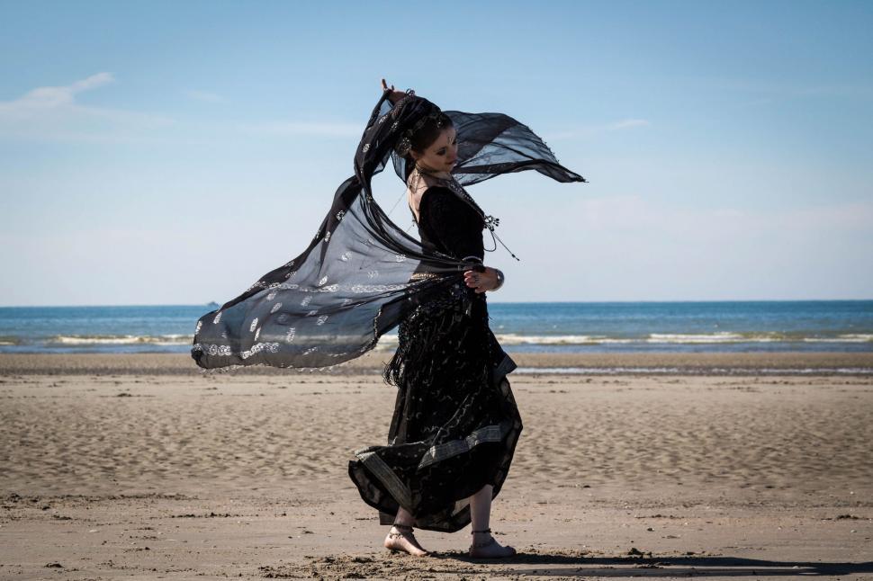 Free Image of Woman in Black Dress on Beach 