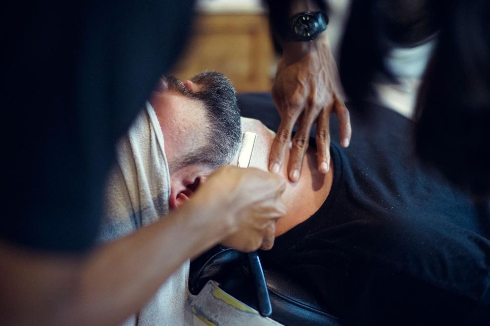 Free Image of A Man Getting His Hair Cut by a Barber 