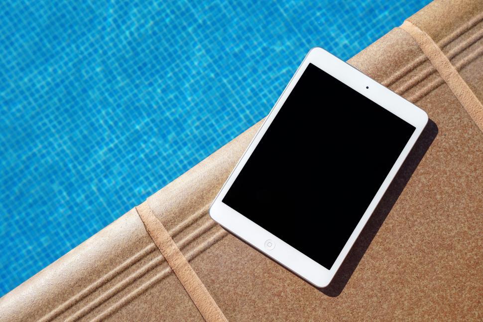 Free Image of Tablet Computer on Table by Swimming Pool 