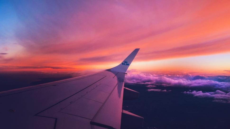 Free Image of The Wing of an Airplane at Sunset 