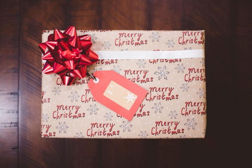 Free Image of Present Wrapped in Wrapping Paper With Red Bow 