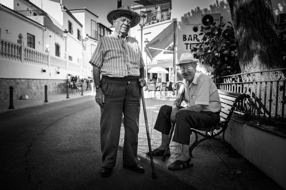 Free Image of Two Men Standing Together on a Street 