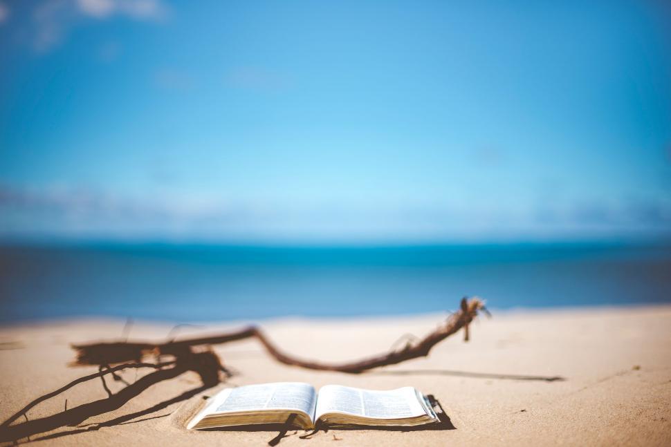 Free Image of Open Book on Sandy Beach 