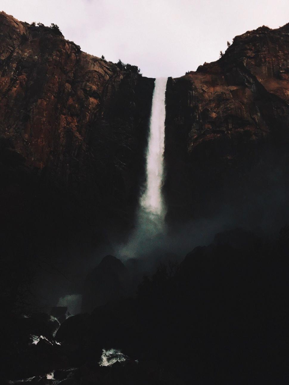 Free Image of Majestic Waterfall Towering in Mountain Landscape 