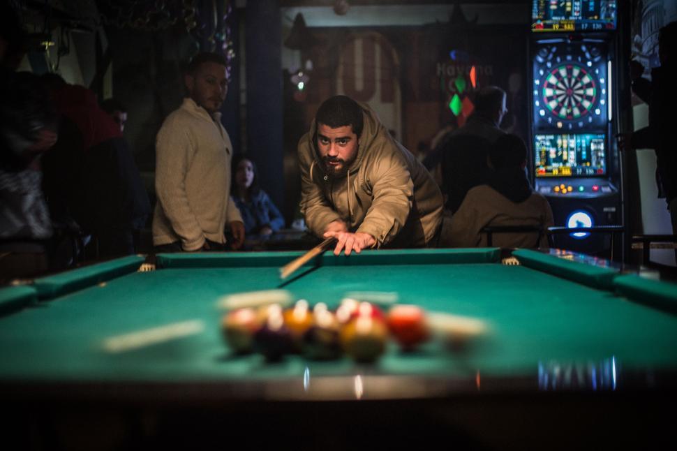 Free Image of Man Leaning Over Pool Table With Cue 