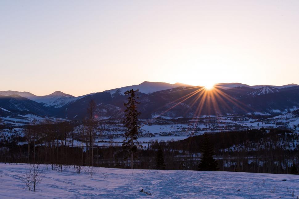 Free Image of Sun Setting Over Snowy Mountains 