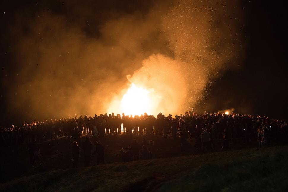Free Image of Large Crowd of People Standing Around a Fire 