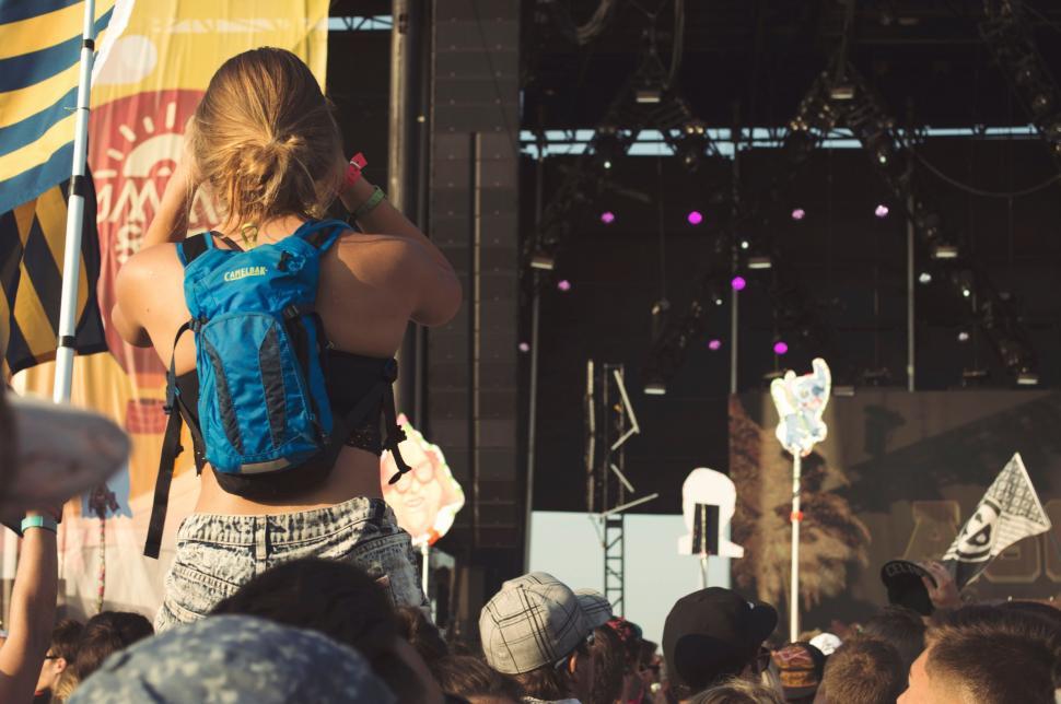 Free Image of Woman With Blue Backpack on Stage 