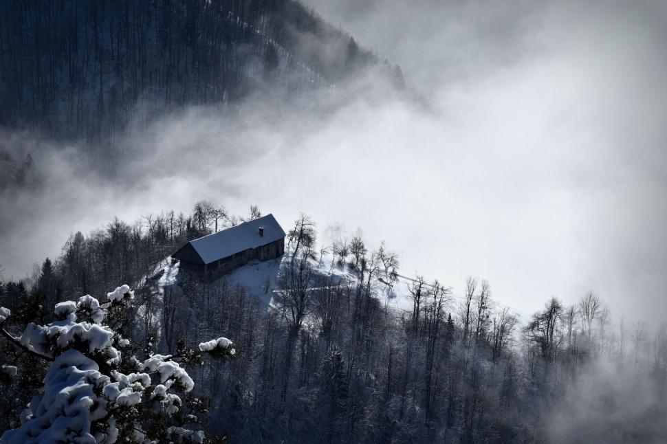 Free Image of A Snowy Mountain With a House 