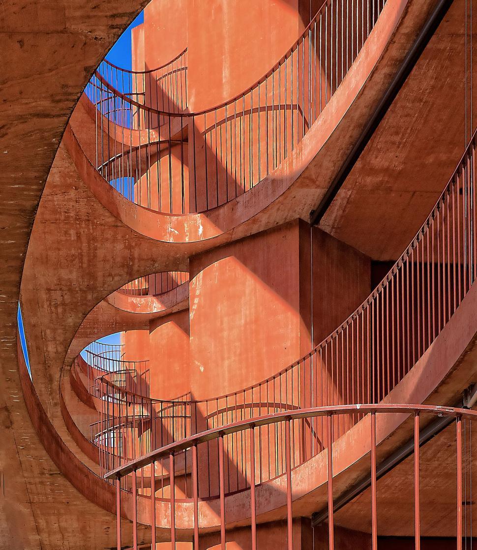 Free Image of Spiral Staircase in Building With Orange Walls 