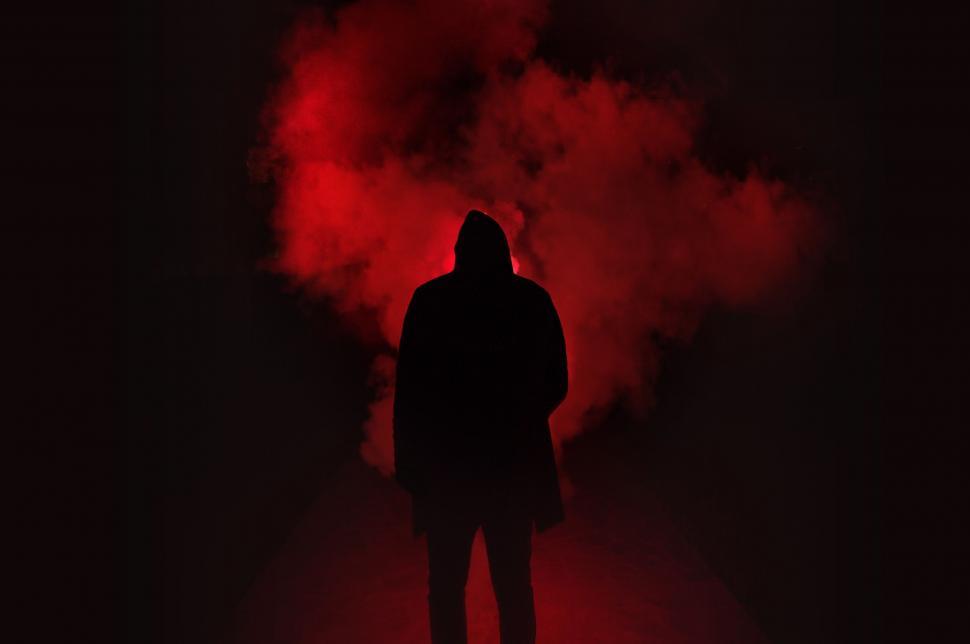 Free Image of Man Standing in Front of Red Smoke 