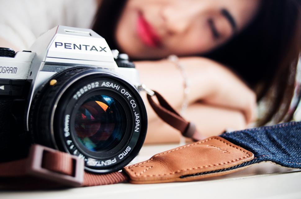 Free Image of Woman Laying on Bed With Camera 