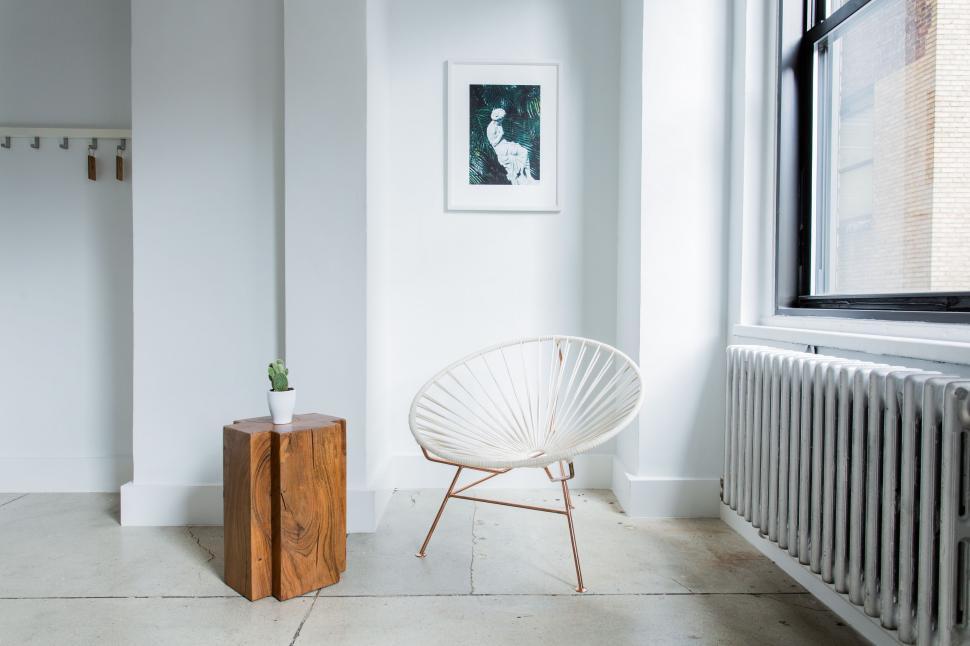 Free Image of White Chair Next to Radiator in Room 