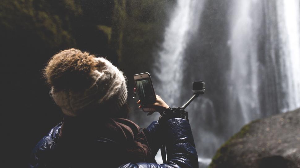 Free Image of Person Capturing Waterfall Scene 