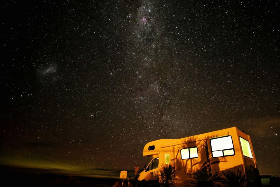 Free Image of Yellow Trailer Parked Under a Star-Filled Night Sky 