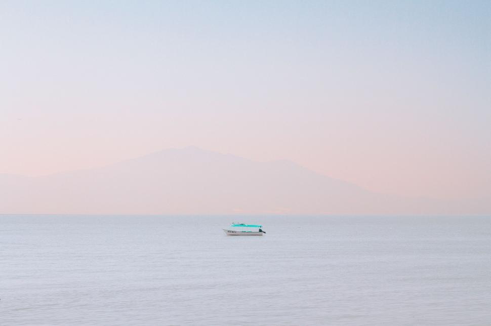 Free Image of Boat Floating in the Middle of Large Body of Water 