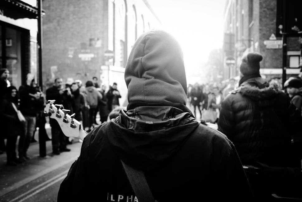 Free Image of Person in Hooded Jacket Walking Down Street 