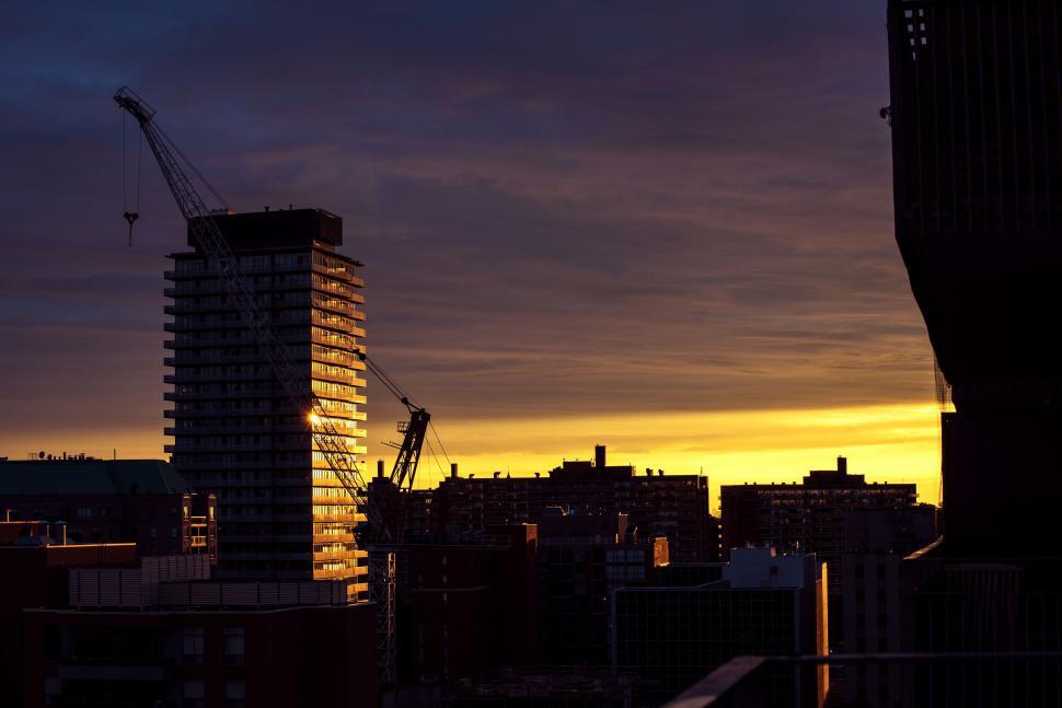 Free Image of Tall Building and Crane in Background 