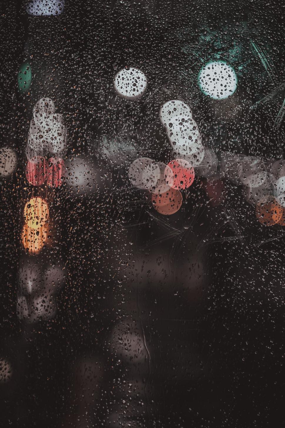Free Image of Rain Drops on a Window With Traffic Lights 