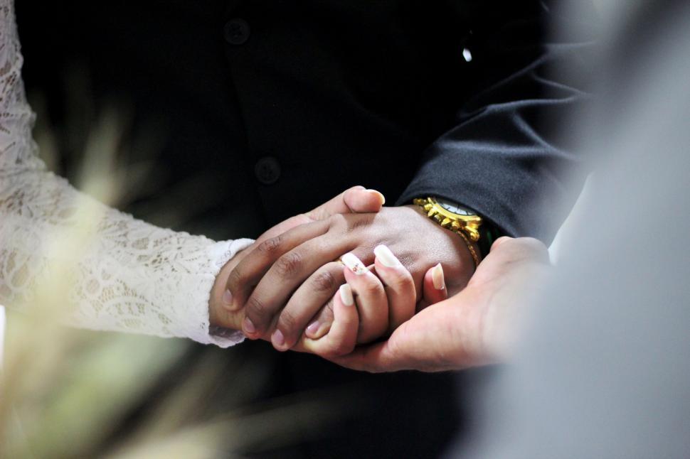 Free Image of Close Up of Two People Holding Hands 