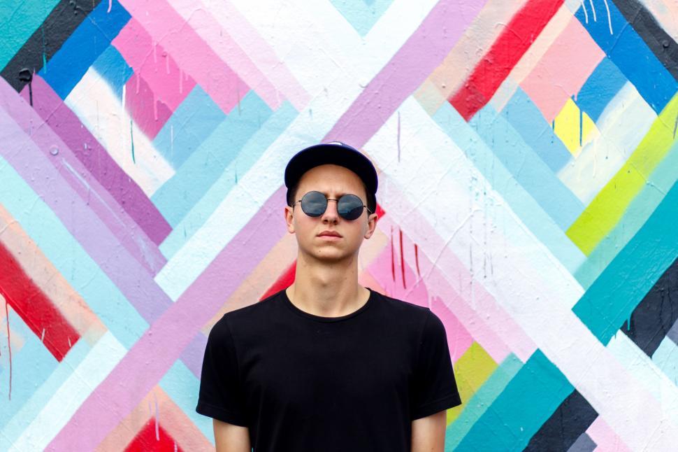 Free Image of Man Standing in Front of Colorful Wall 