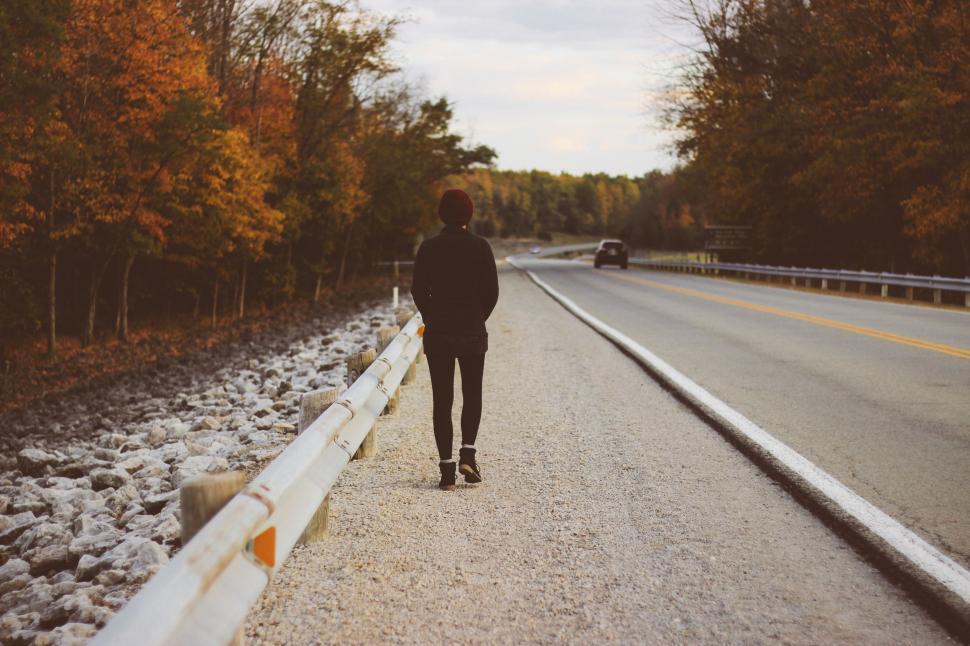 Free Image of Person Walking Down a Road in Fall 