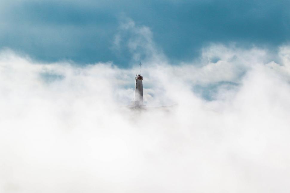 Free Image of Towering Tower Over Cloud-Filled Sky 