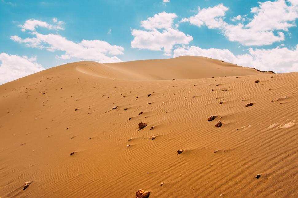 Free Image of Large Sand Dune With Footprints 