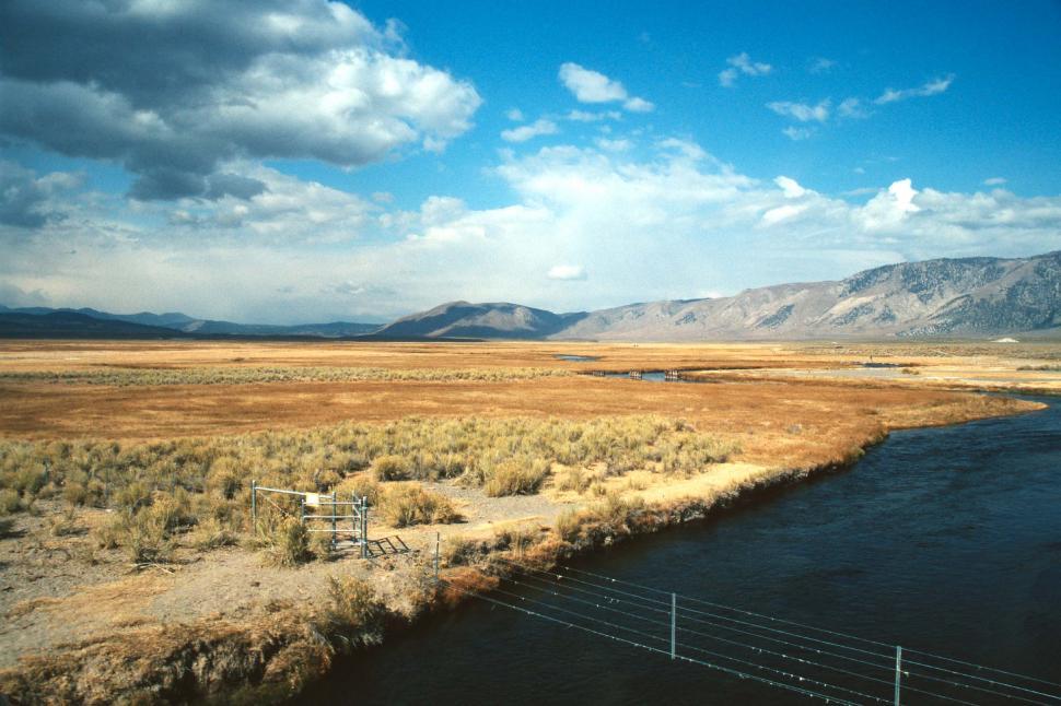 Free Image of River Flowing Through Dry Grass Field 