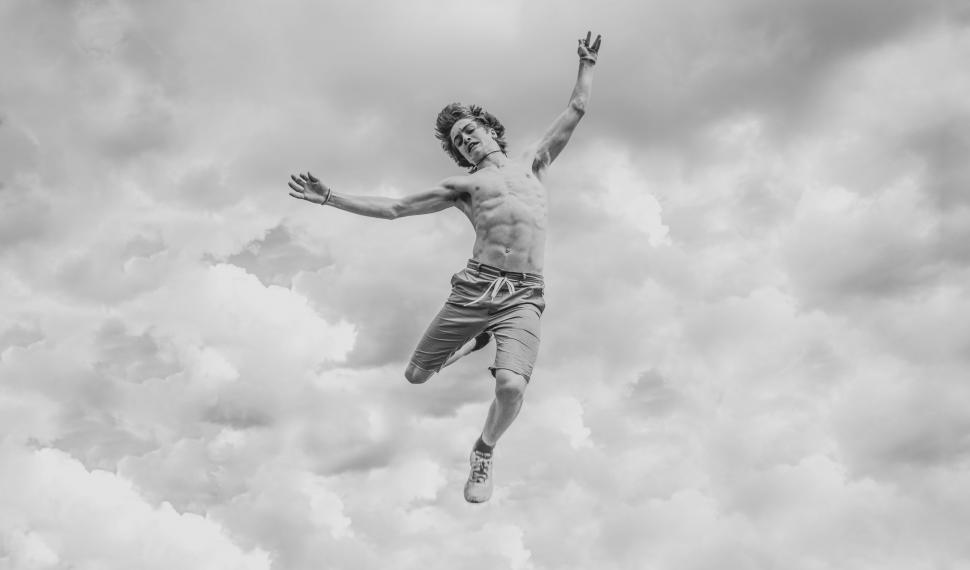 Free Image of Man Jumping in the Air With Frisbee 