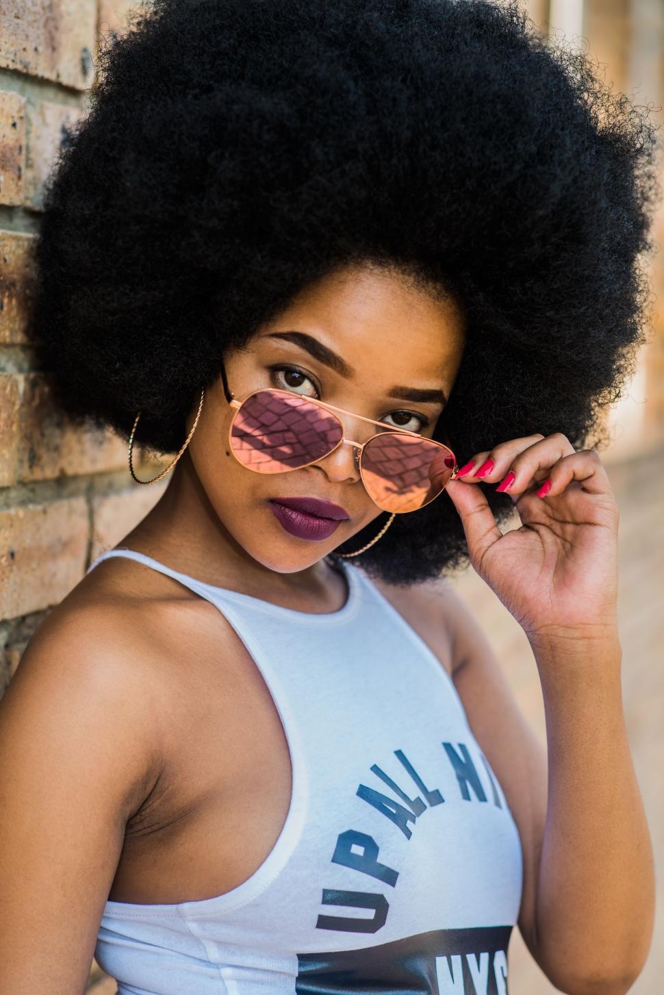 Free Image of Woman Wearing Sunglasses and Tank Top 