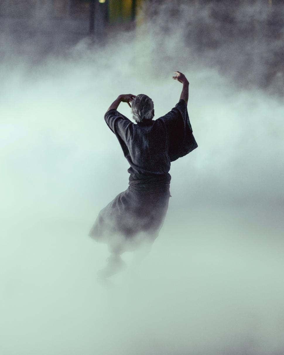 Free Image of Man Dancing in Foggy Area 
