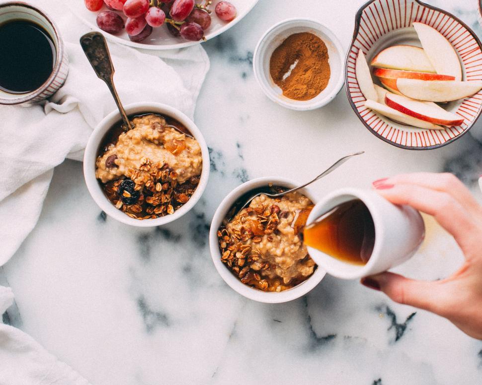 Free Image of Two Bowls of Oatmeal and a Cup of Coffee on a Marble Table 
