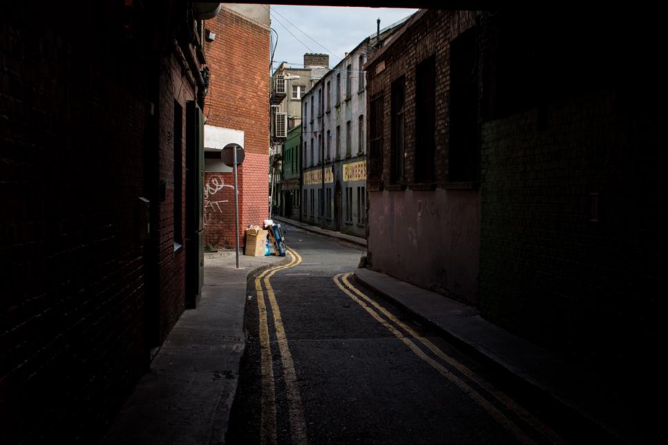 Free Image of Person Walking Down Narrow Alleyway 