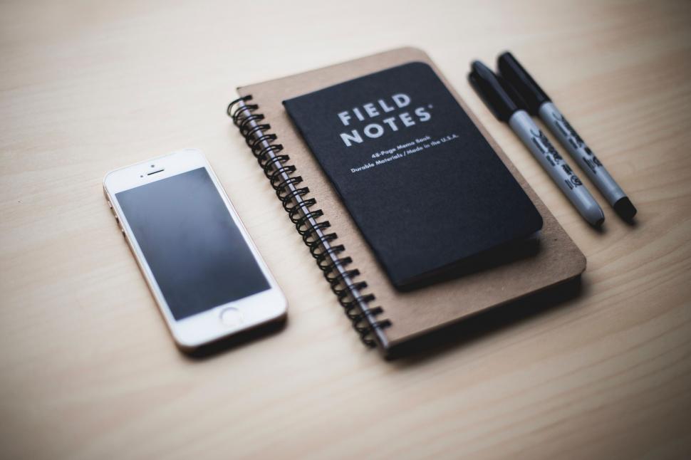 Free Image of Notebook, Pen, and Cell Phone on Table 