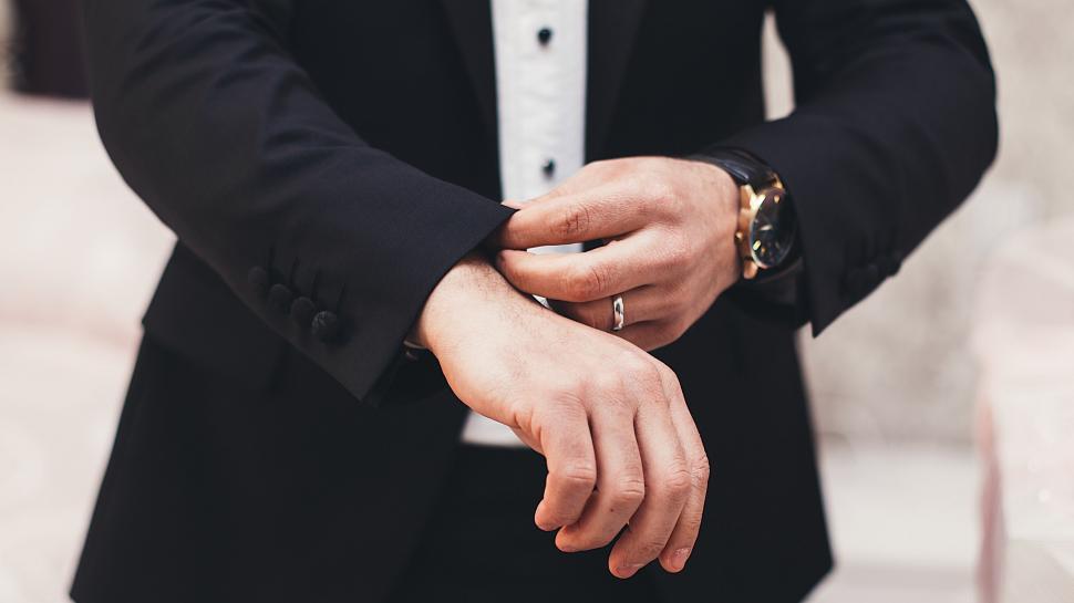 Free Image of Stylish Man in Tuxedo With Watch on Wrist 