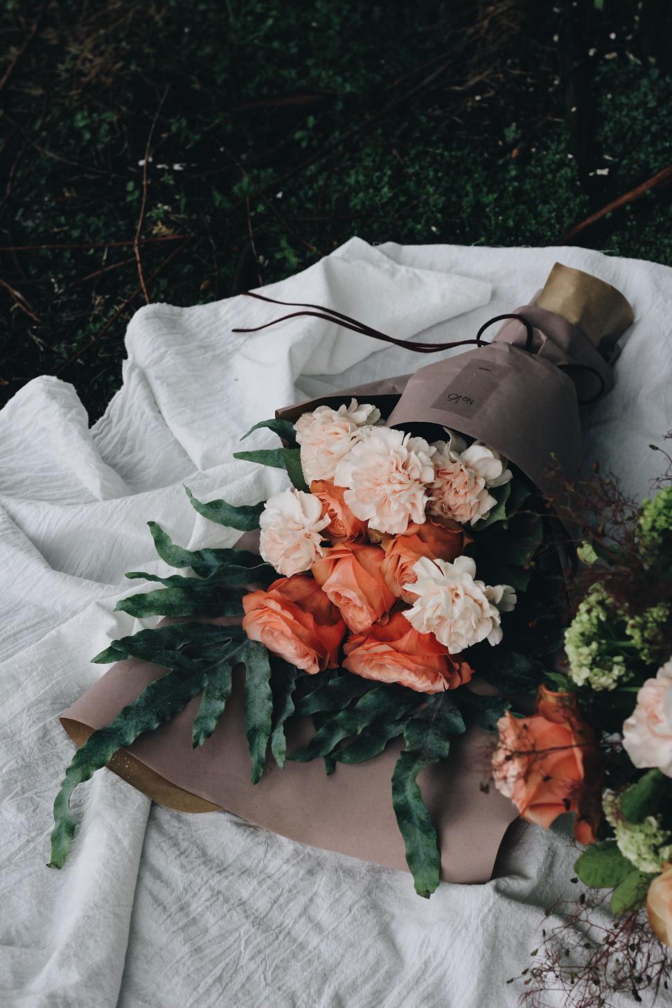 Free Image of Bouquet of Flowers Laying on Blanket 