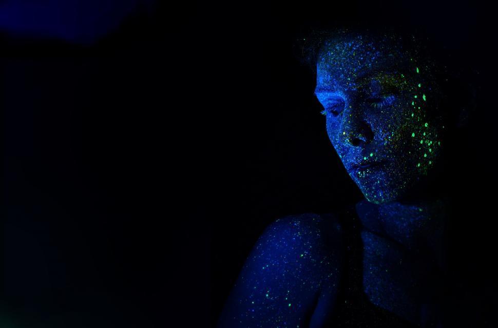 Free Image of Woman With Blue Body Paint in the Dark 