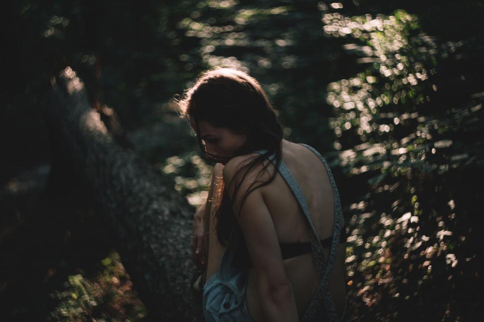 Free Image of Woman Walking Through Forest at Night 