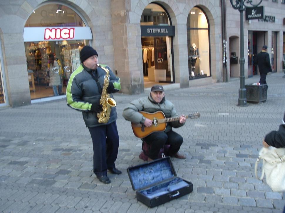 Free Image of Group of People Playing Instruments on City Street 