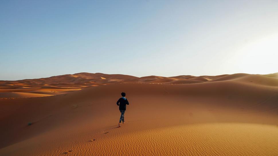Free Image of Man Running Across Sandy Field in Desert 