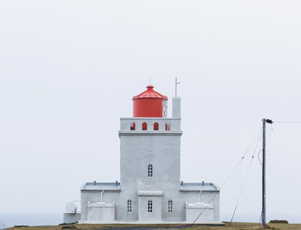 Free Image of Red and White Lighthouse on Foggy Day 