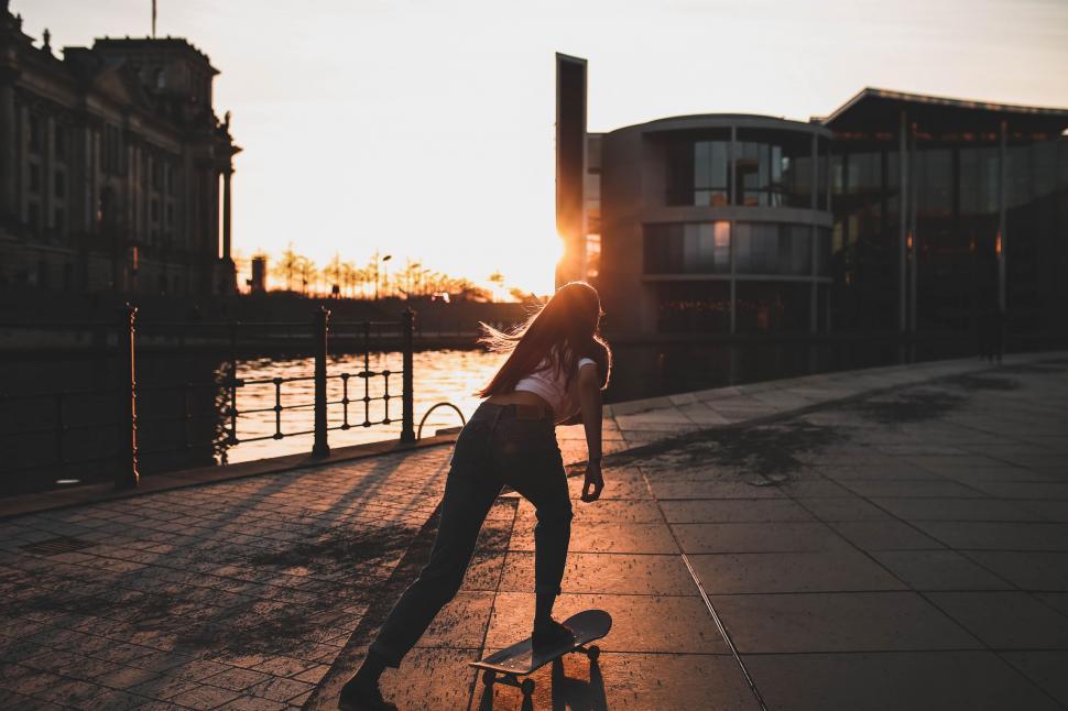 Free Image of Person Riding Skateboard on Sidewalk 