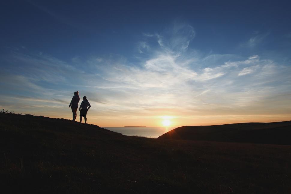 Free Image of Couple Standing on Top of a Hill 