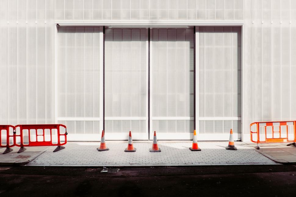 Free Image of Group of Orange Traffic Cones in Front of Building 
