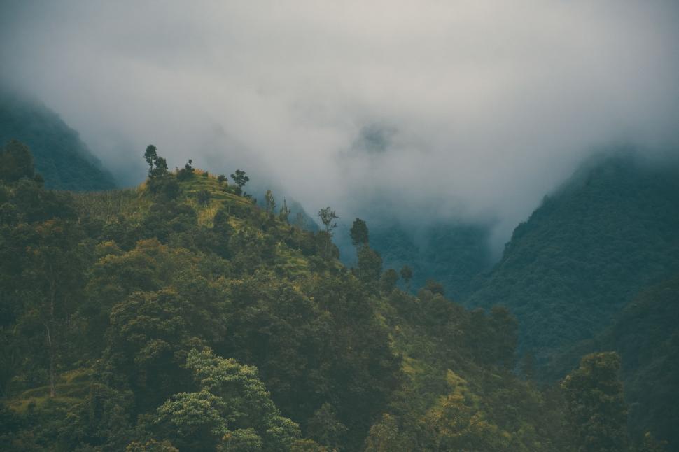 Free Image of Cloud-Covered Mountain With Trees on a Cloudy Day 