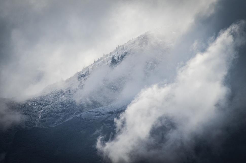 Free Image of Towering Mountain Shrouded in Clouds 