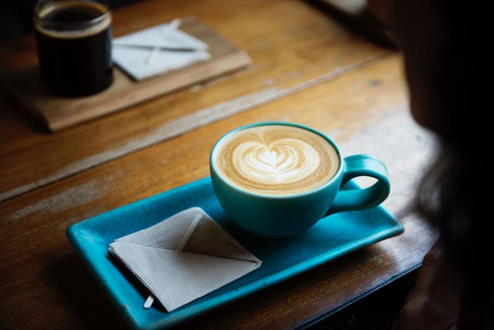 Free Image of A Cappuccino on a Blue Plate on a Wooden Table 
