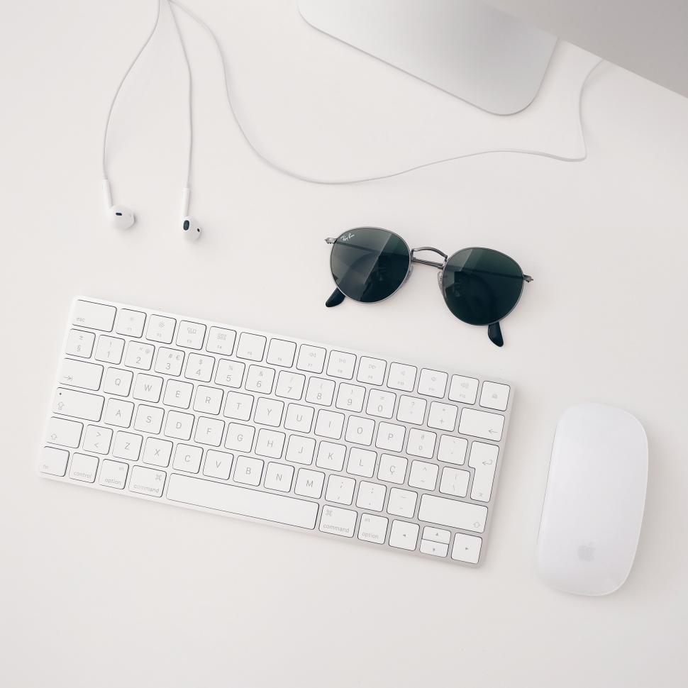 Free Image of Computer Keyboard, Sunglasses, and Headphones on Desk 