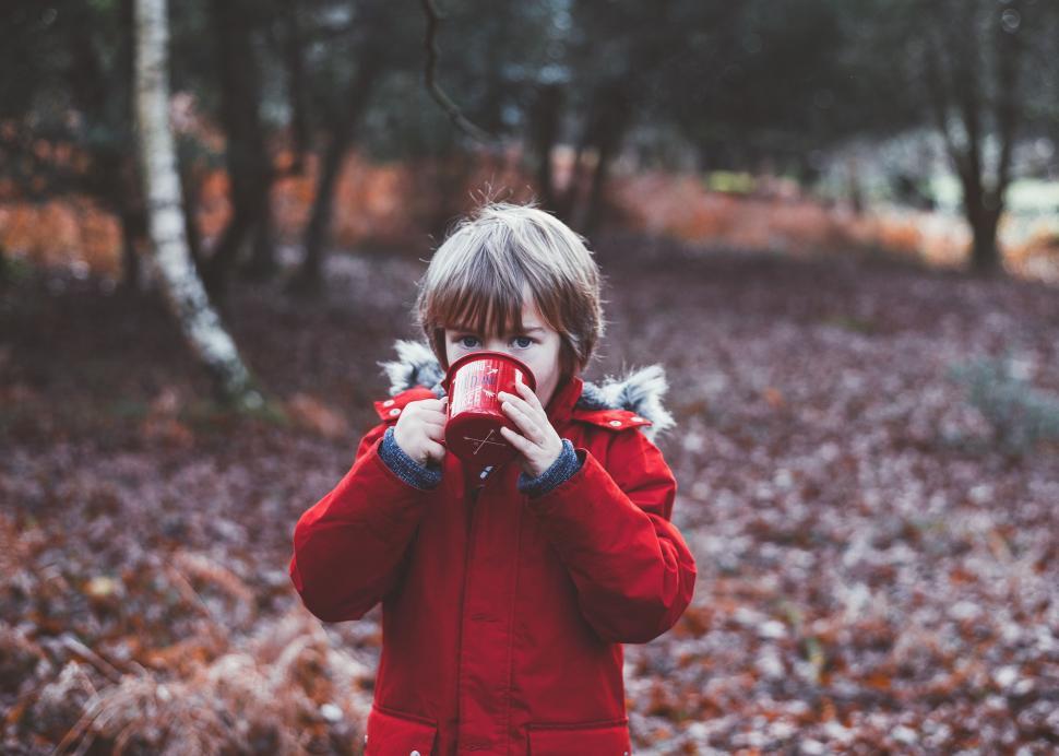 Free Image of Little Boy in Red Jacket Taking Picture With Camera 
